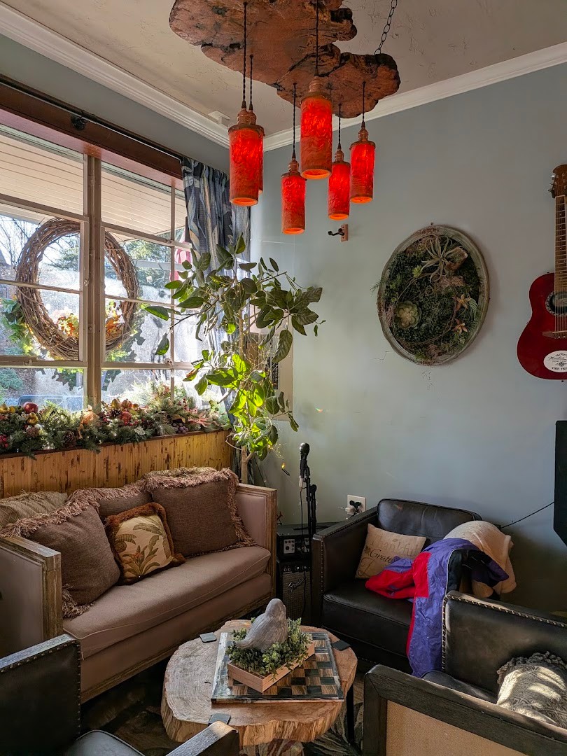 Couches and red lanterns in a cozy corner of the lounge, guitar resting nearby